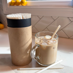 Compostable agave reusable straw in an iced coffee cup next to kraft case