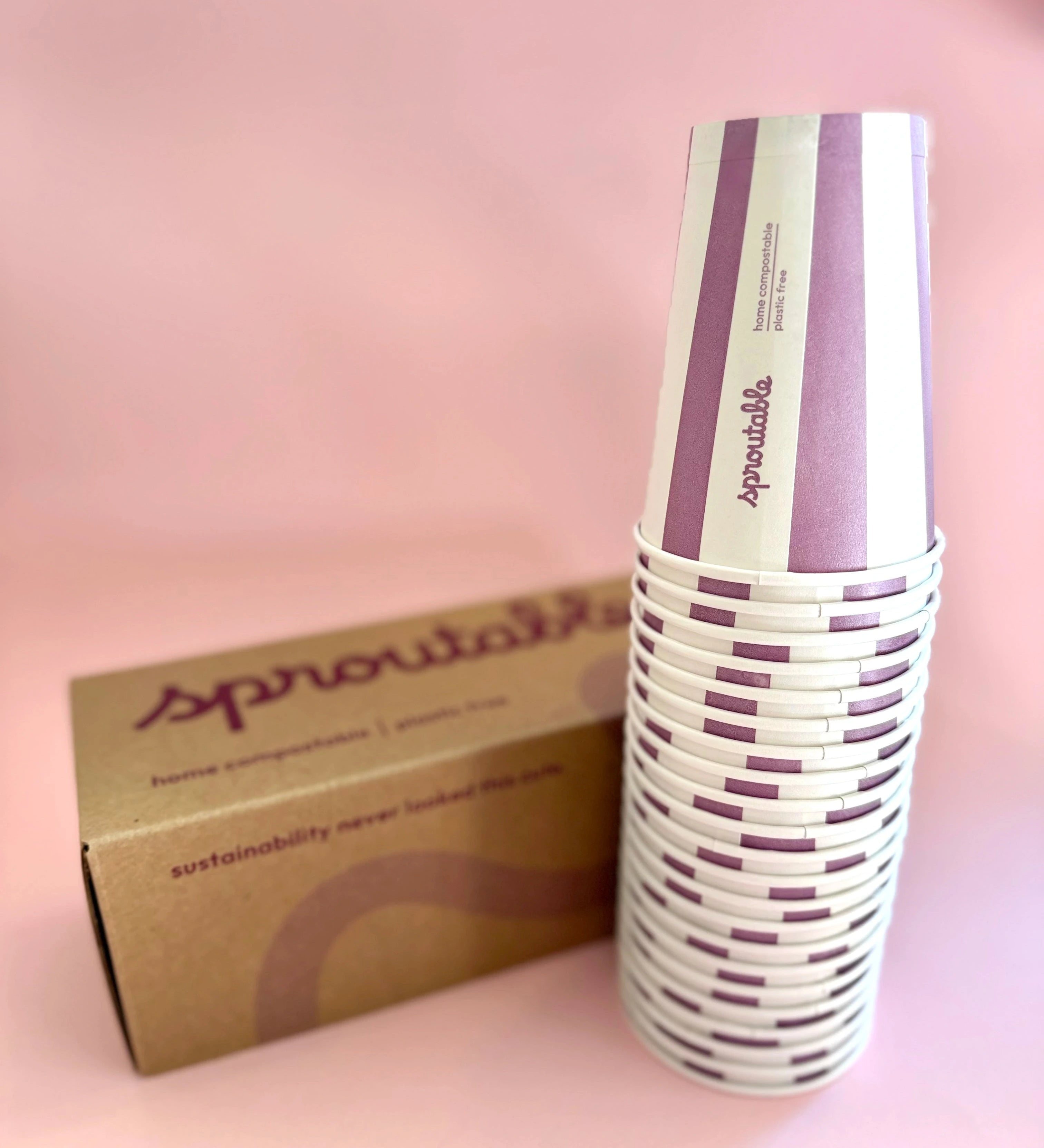 Stack of 22 Sproutable mauve striped 12oz home compostable cups next to branded box – plant fiber, home compostable, plastic-free