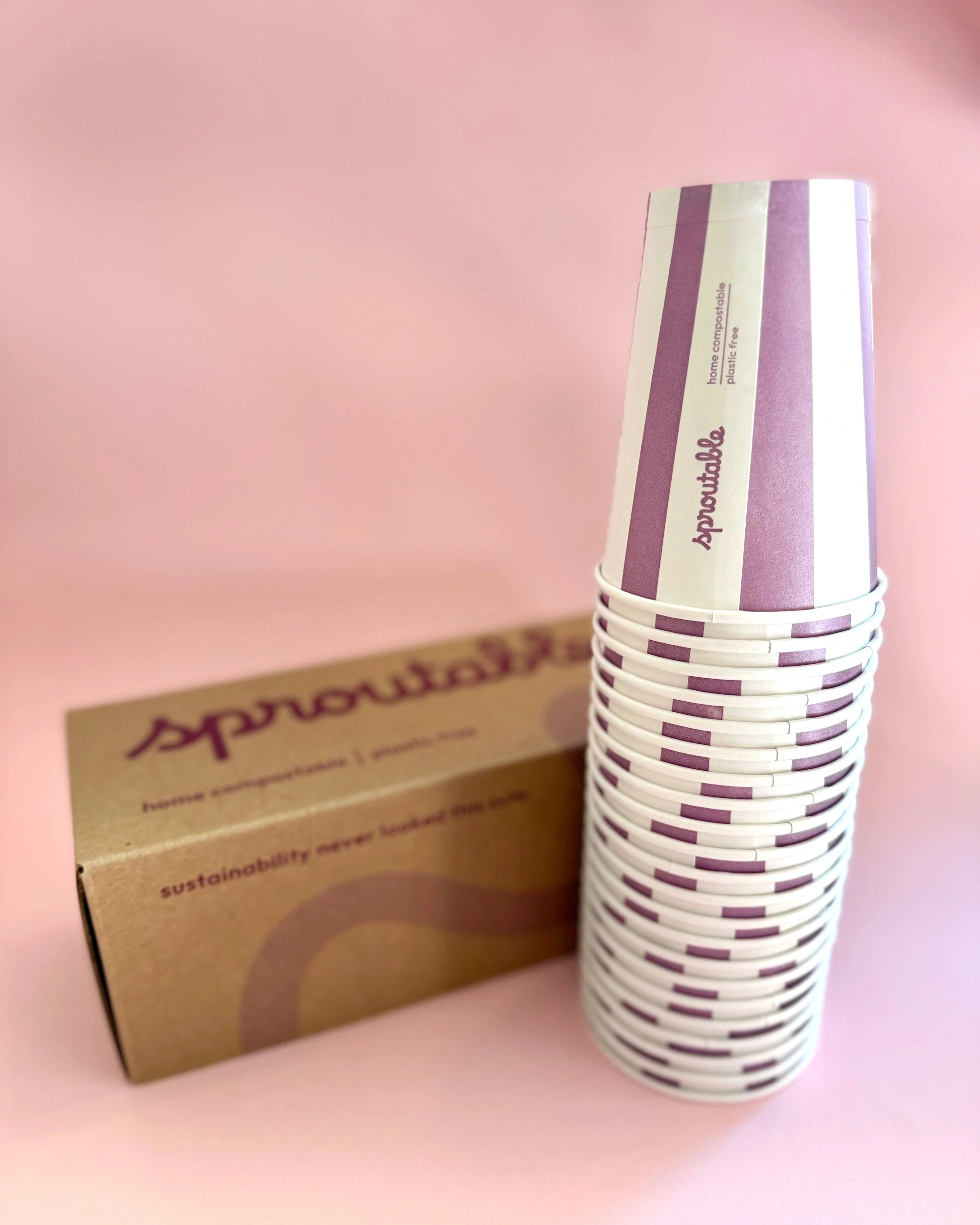 Stack of 22 Sproutable mauve striped 12oz home compostable cups next to branded box – plant fiber, home compostable, plastic-free